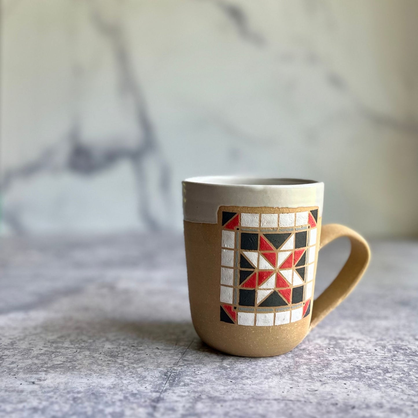 Mug with geometric pattern on a marble surface