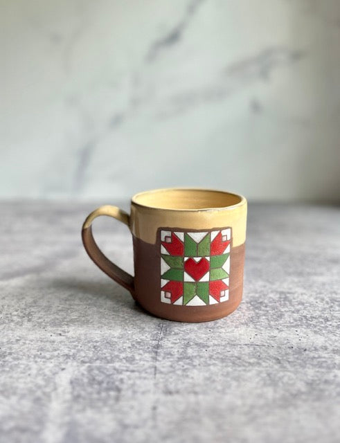 Handmade ceramic tulip and heart barn quilt mug on chocolate clay.