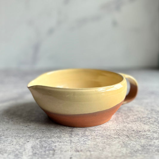 Ceramic mixing bowl with a gradient design on a gray surface