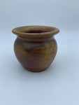 Small salt wood fired pot, golden tan color with hints of red and browns. Aprox dimensions: 3 1/2" tall by 4" wide